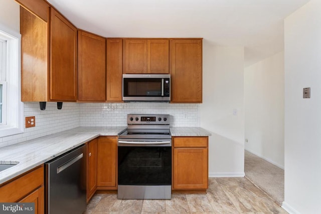 19253 Rolling Hills Dr, Culpeper, VA 22701 - kitchen with stainless steel appliances, brown cabinetry, and backsplash