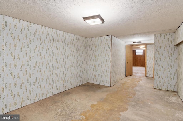 19253 Rolling Hills Dr, Culpeper, VA 22701 - empty room with unfinished concrete flooring, a textured ceiling, and wallpapered walls