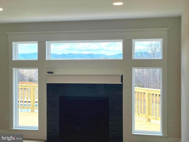 interior details featuring recessed lighting and a fireplace with flush hearth