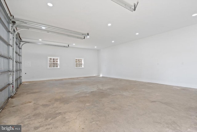 garage with recessed lighting and baseboards