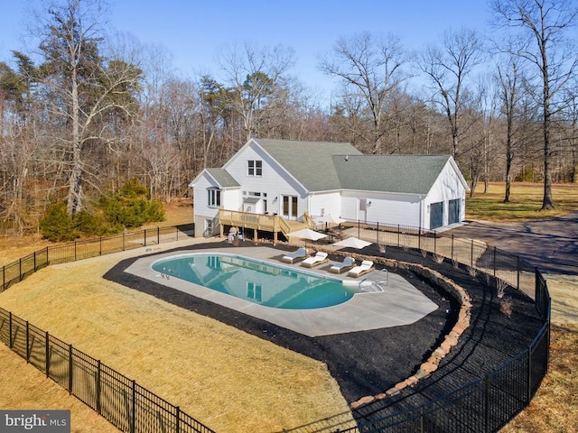 view of swimming pool featuring a deck, a patio area, fence, and a fenced in pool