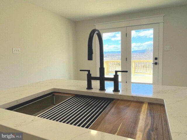 details featuring light stone counters and a sink