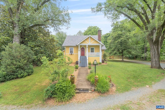 2523 Stony Point Rd, Charlottesville, VA 22911 - view of front of house featuring a front lawn, a chimney, stairway, stucco siding, and covered porch