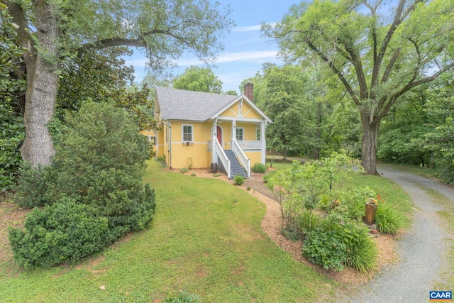 2523 Stony Point Rd, Charlottesville, VA 22911 - view of front of property with stairway, a porch, a chimney, stucco siding, and a front lawn