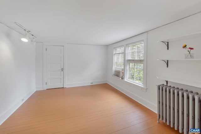 2523 Stony Point Rd, Charlottesville, VA 22911 - spare room with radiator heating unit, light wood-style flooring, and track lighting