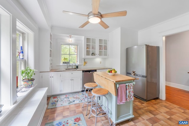 2523 Stony Point Rd, Charlottesville, VA 22911 - kitchen with stainless steel appliances, white cabinetry, glass insert cabinets, ornamental molding, and ceiling fan