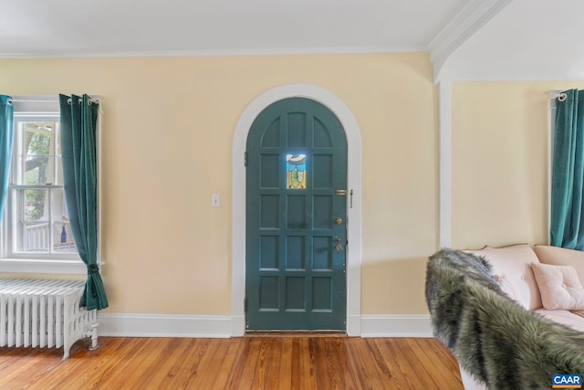 2523 Stony Point Rd, Charlottesville, VA 22911 - foyer entrance with radiator heating unit, arched walkways, wood finished floors, and crown molding