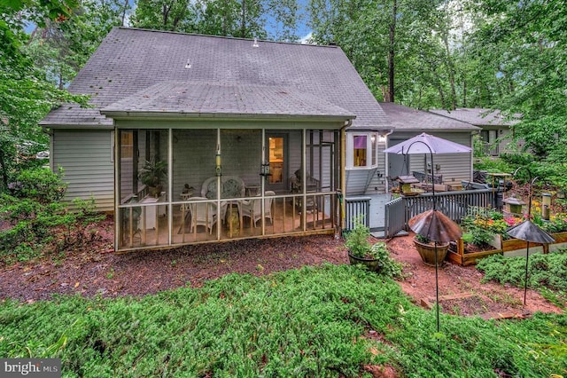 215 Mt Pleasant Dr, Locust Grove, VA 22508 - rear view of house featuring a sunroom, a deck, a shingled roof, and outdoor dining area