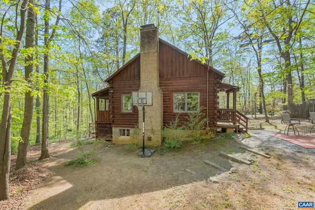 711 Jefferson Dr, Palmyra, VA 22963 - view of side of property featuring log siding, a chimney, and a patio