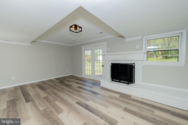  - unfurnished living room featuring wood finished floors, ornamental molding, visible vents, a fireplace, and baseboards