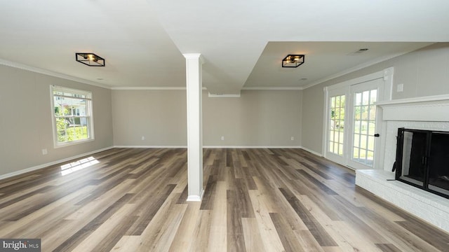  - basement with baseboards, a healthy amount of sunlight, and wood finished floors
