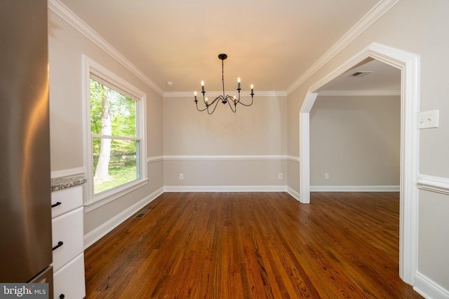  - unfurnished dining area featuring a chandelier, ornamental molding, visible vents, and dark wood finished floors
