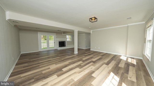  - unfurnished living room with a fireplace, baseboards, visible vents, and wood finished floors