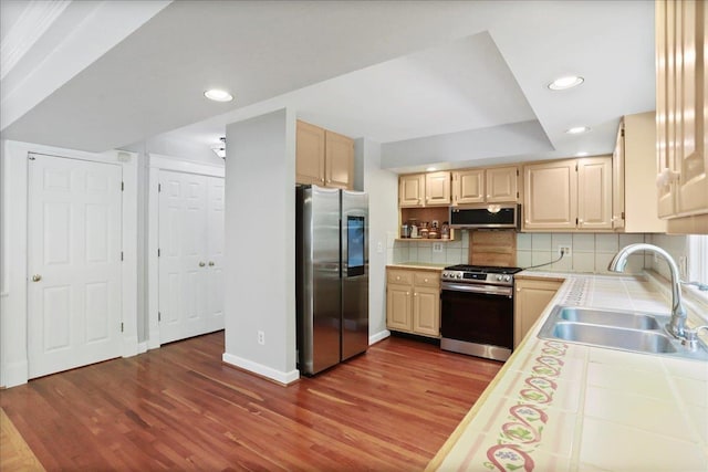 162 Hartman Ct, Mcgaheysville, VA 22840 - kitchen featuring appliances with stainless steel finishes, tile counters, dark wood-style floors, recessed lighting, and tasteful backsplash