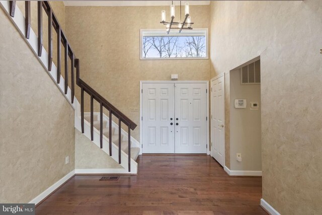 9 Twin Springs Dr, Fredericksburg, VA 22407 - foyer featuring stairway, a chandelier, wood finished floors, a towering ceiling, and baseboards