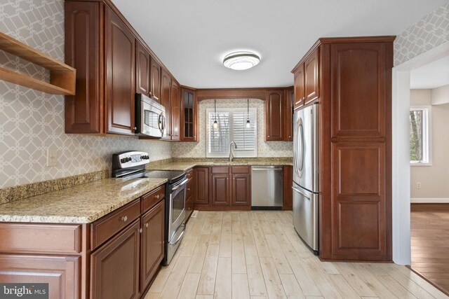 9 Twin Springs Dr, Fredericksburg, VA 22407 - kitchen featuring stainless steel appliances, a sink, wallpapered walls, light wood-style flooring, and light stone countertops