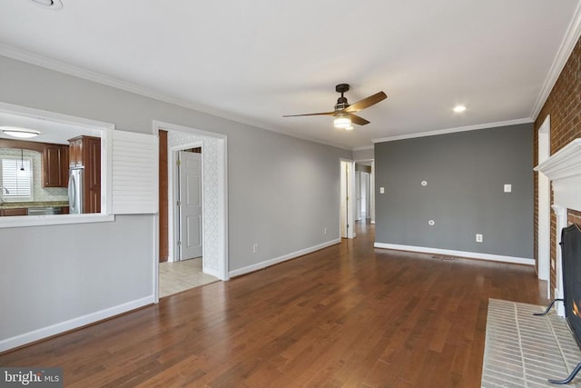 9 Twin Springs Dr, Fredericksburg, VA 22407 - unfurnished living room featuring a ceiling fan, baseboards, wood finished floors, ornamental molding, and a fireplace