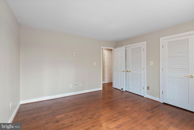 9 Twin Springs Dr, Fredericksburg, VA 22407 - unfurnished bedroom featuring wood-type flooring, two closets, and baseboards