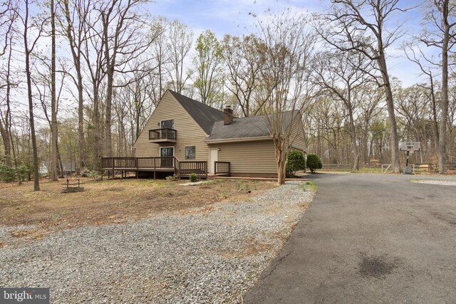 9 Twin Springs Dr, Fredericksburg, VA 22407 - view of home's exterior featuring a wooden deck, a chimney, asphalt driveway, and a shingled roof