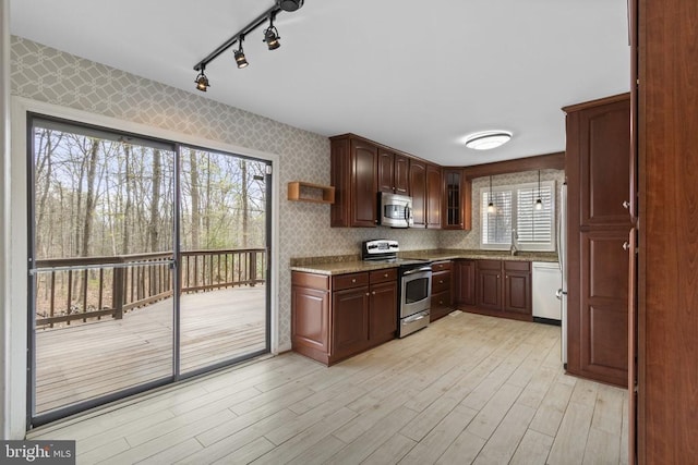 9 Twin Springs Dr, Fredericksburg, VA 22407 - kitchen with stainless steel appliances, track lighting, light wood finished floors, light stone countertops, and wallpapered walls