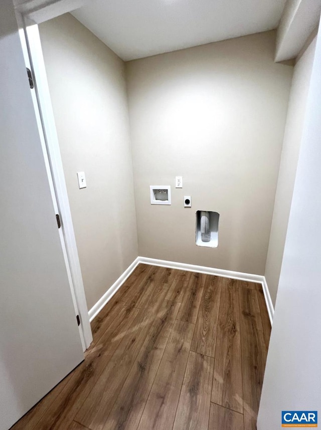 washroom featuring wood finished floors, laundry area, hookup for an electric dryer, hookup for a washing machine, and baseboards
