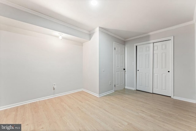  - unfurnished bedroom with light wood-type flooring, crown molding, and a closet