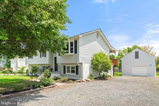  - view of front of house with a garage, gravel driveway, and an outdoor structure
