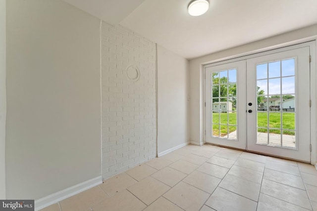  - unfurnished room with french doors and light tile patterned flooring