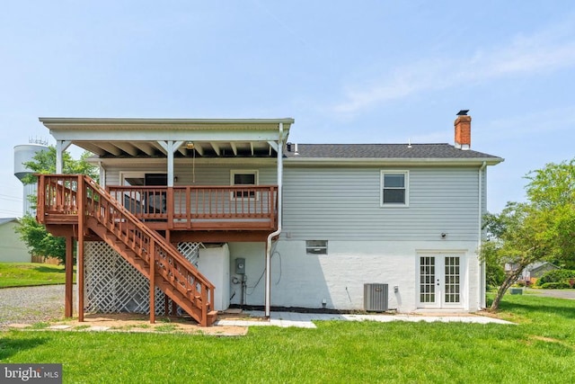  - back of property with french doors, a chimney, a lawn, a wooden deck, and stairs