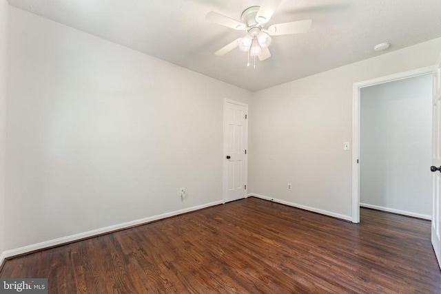  - unfurnished room with dark wood finished floors and a ceiling fan