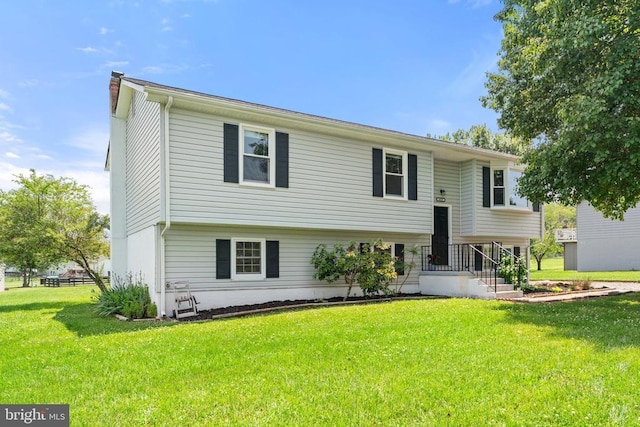  - view of front of property featuring a front lawn and a chimney