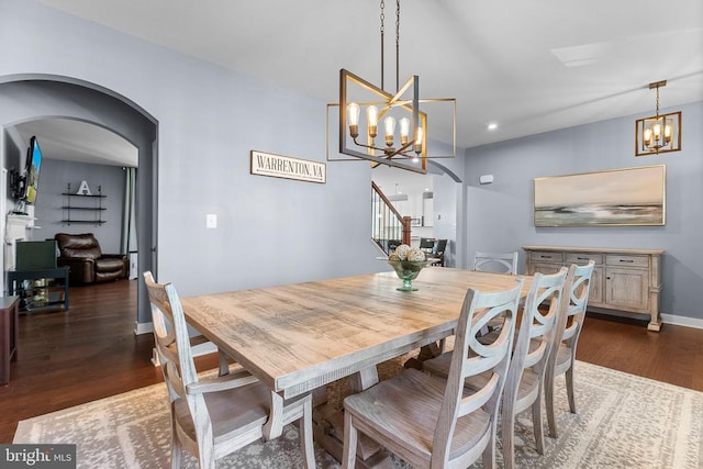  - dining room with a chandelier, dark wood finished floors, arched walkways, and recessed lighting