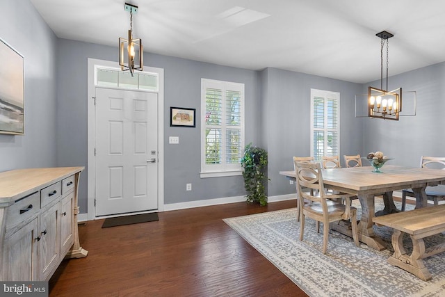  - dining room featuring a chandelier and dark wood-style flooring