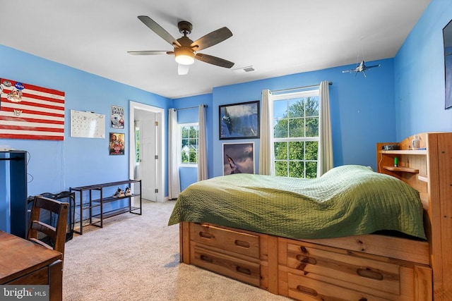  - bedroom featuring light carpet and a ceiling fan