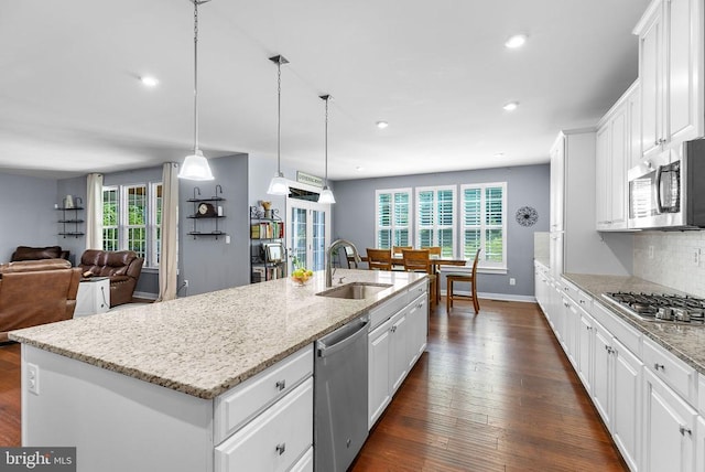  - kitchen with appliances with stainless steel finishes, dark wood-type flooring, healthy amount of natural light, white cabinets, and recessed lighting