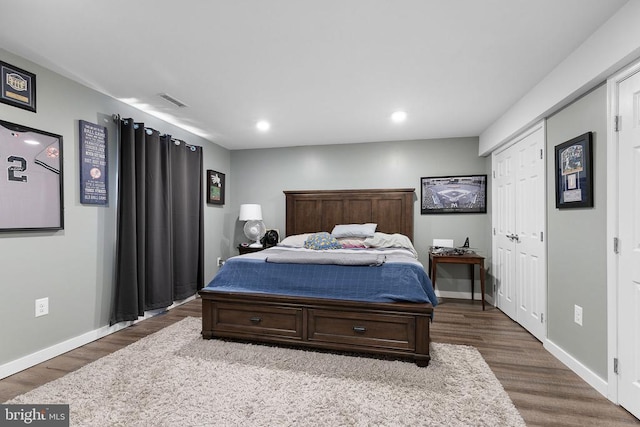  - bedroom with dark wood-style floors and recessed lighting