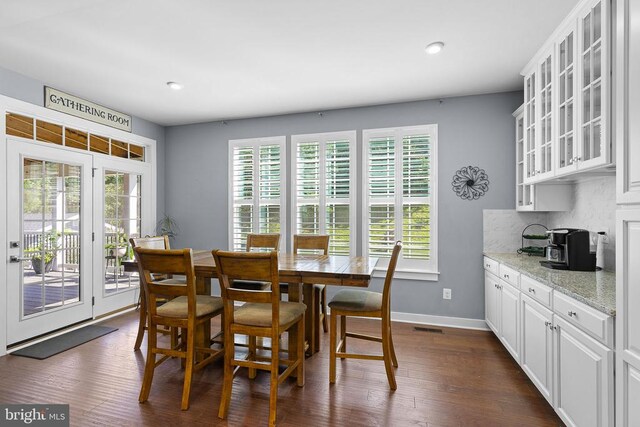  - dining room with dark wood finished floors and recessed lighting