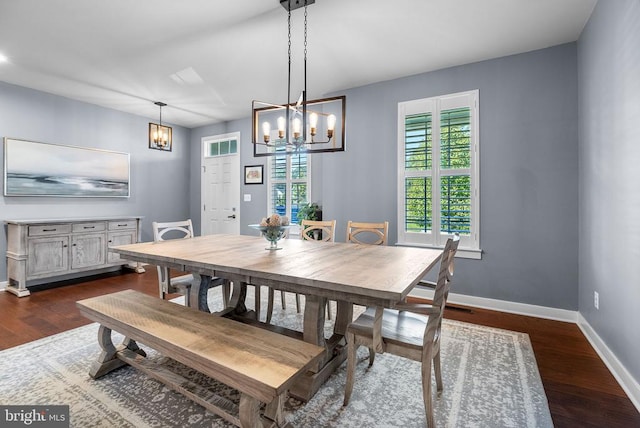  - dining area with a chandelier and dark wood-style floors