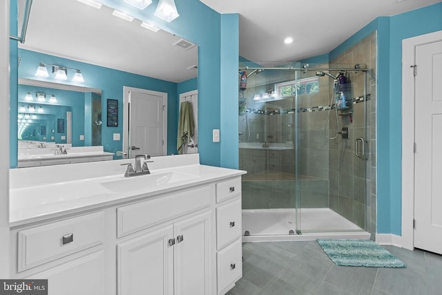  - full bath with vanity, a shower stall, tile patterned floors, and recessed lighting