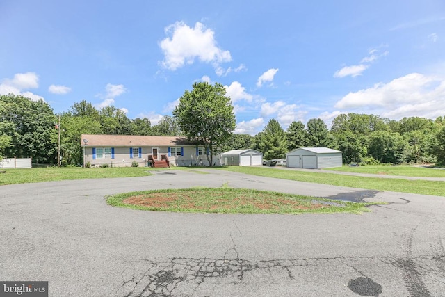 4253 Rolling Hills Dr, Culpeper, VA 22701 - single story home with a detached garage, a front lawn, and a storage unit
