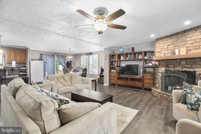 4253 Rolling Hills Dr, Culpeper, VA 22701 - living area with ceiling fan, dark wood finished floors, a textured ceiling, a stone fireplace, and recessed lighting
