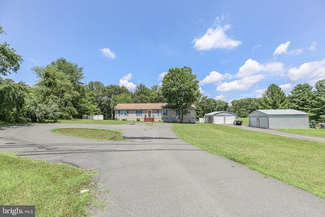 4253 Rolling Hills Dr, Culpeper, VA 22701 - single story home featuring a detached garage, a front yard, an outdoor structure, and view of wooded area