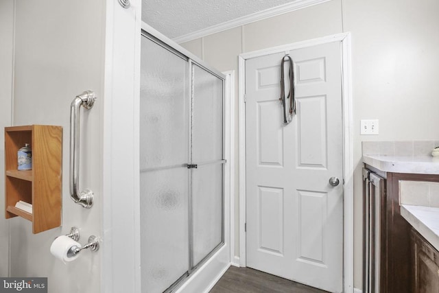 4253 Rolling Hills Dr, Culpeper, VA 22701 - bathroom featuring vanity, a shower stall, wood finished floors, a textured ceiling, and ornamental molding