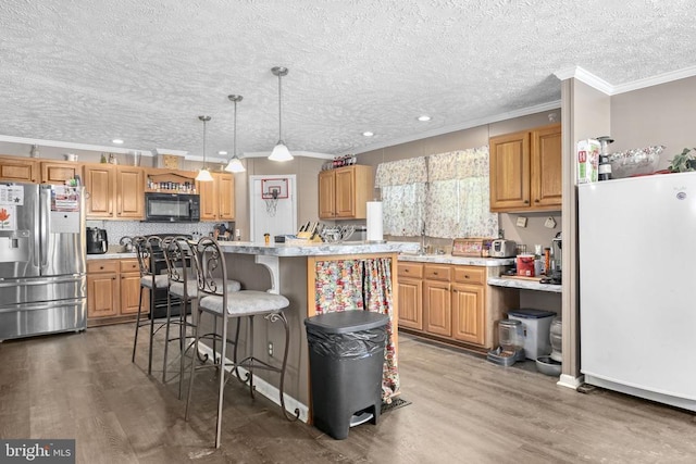 4253 Rolling Hills Dr, Culpeper, VA 22701 - kitchen with stainless steel refrigerator with ice dispenser, black microwave, freestanding refrigerator, light countertops, and ornamental molding