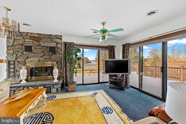 41 Carr Cir, Mineral, VA 23117 - carpeted living area with ceiling fan and a stone fireplace