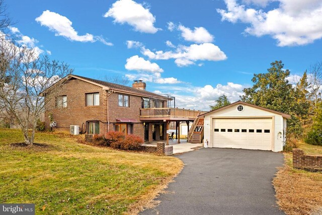 41 Carr Cir, Mineral, VA 23117 - view of front of home featuring a chimney, a front yard, stairway, a detached garage, and central air condition unit