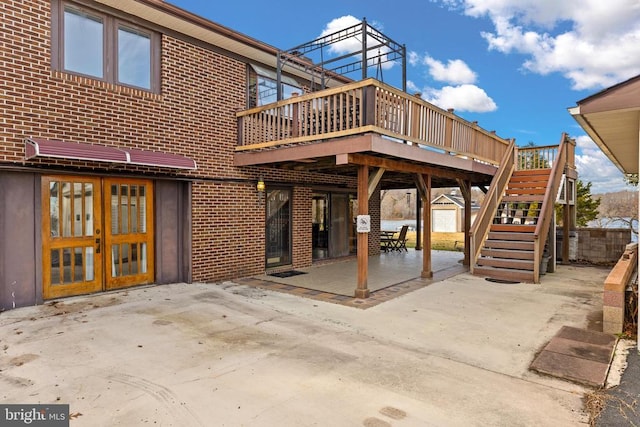 41 Carr Cir, Mineral, VA 23117 - back of property with a patio area, a wooden deck, stairs, and brick siding