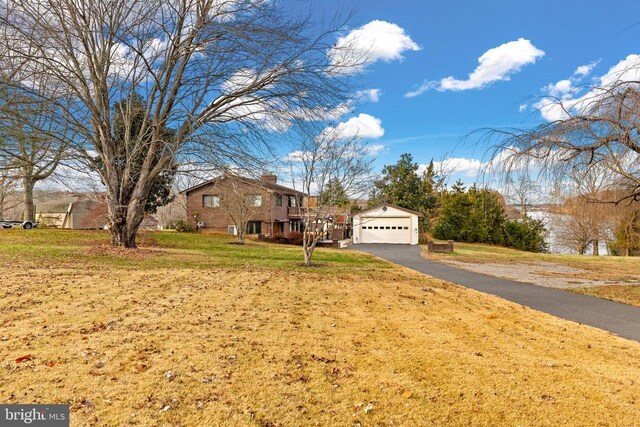 41 Carr Cir, Mineral, VA 23117 - view of front of home with a garage, a front yard, driveway, and a chimney