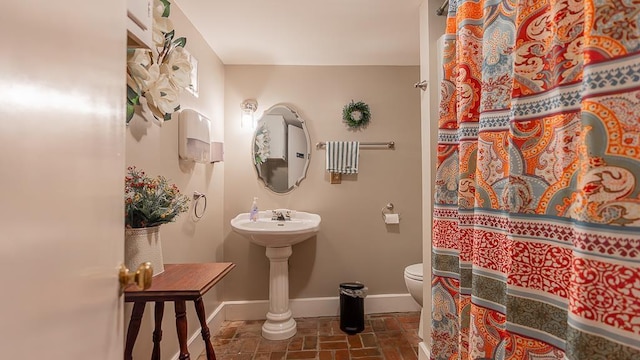 111 Main St S, Bridgewater, VA 22812 - bathroom with baseboards, toilet, and a shower with shower curtain