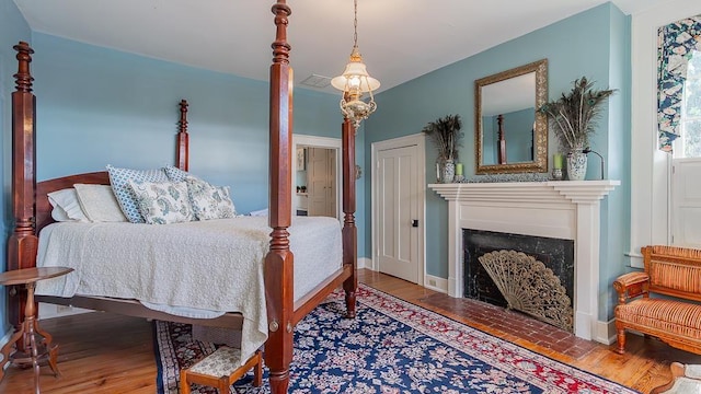 111 Main St S, Bridgewater, VA 22812 - bedroom with a fireplace, wood finished floors, and baseboards